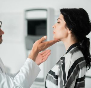 Doctor assessing mid-face volume before cheek fillers in Dublin