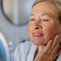 Mini Facelift Dublin MiniLift After image Dr Kahlout woman looking in mirror